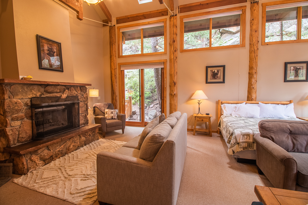 Interior of a Castle Mountain Lodge cabin with fireplace and mountain-inspired décor.